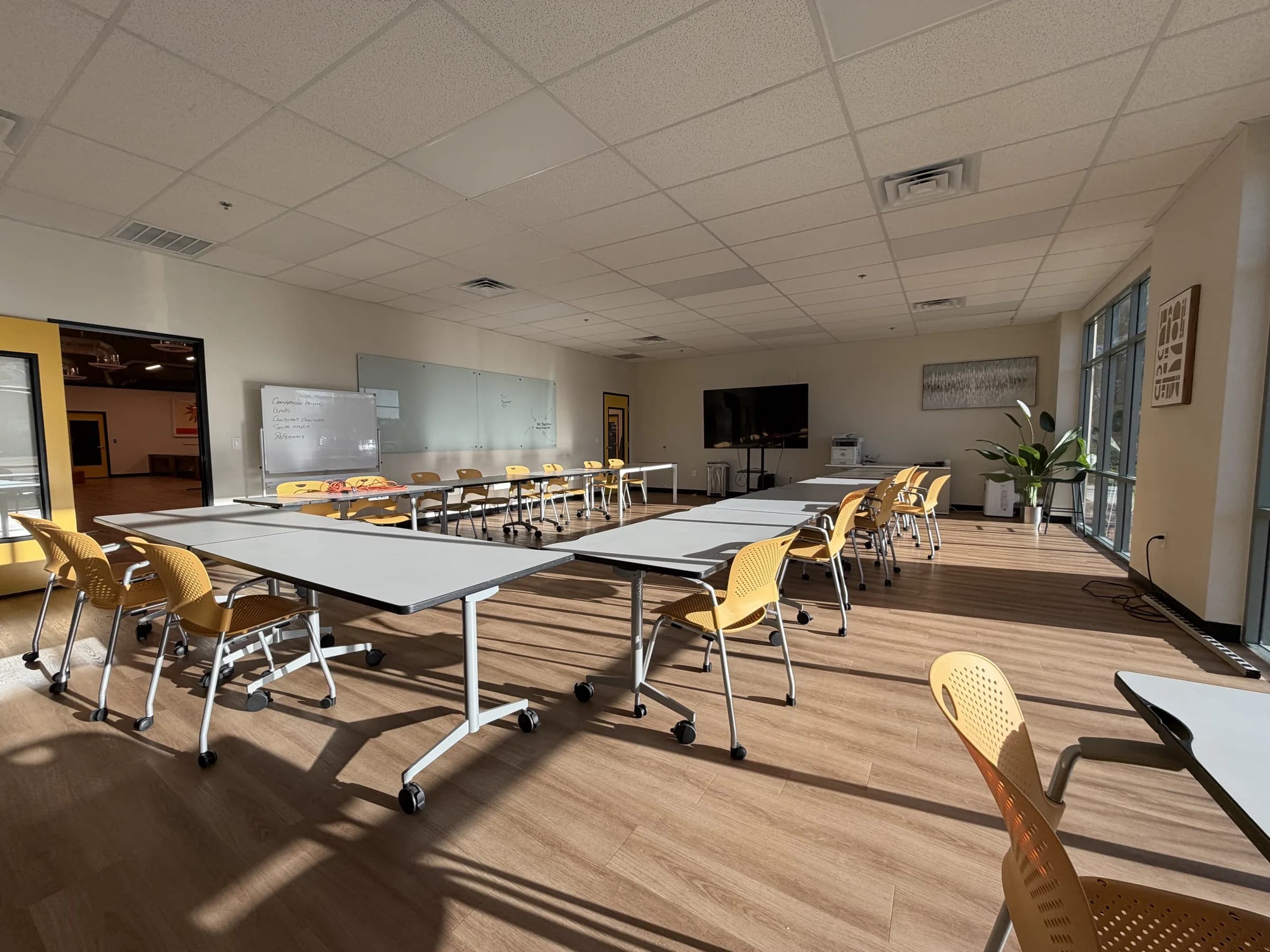 Las Vegas classroom set up with movable tables and yellow chairs for training and workshops