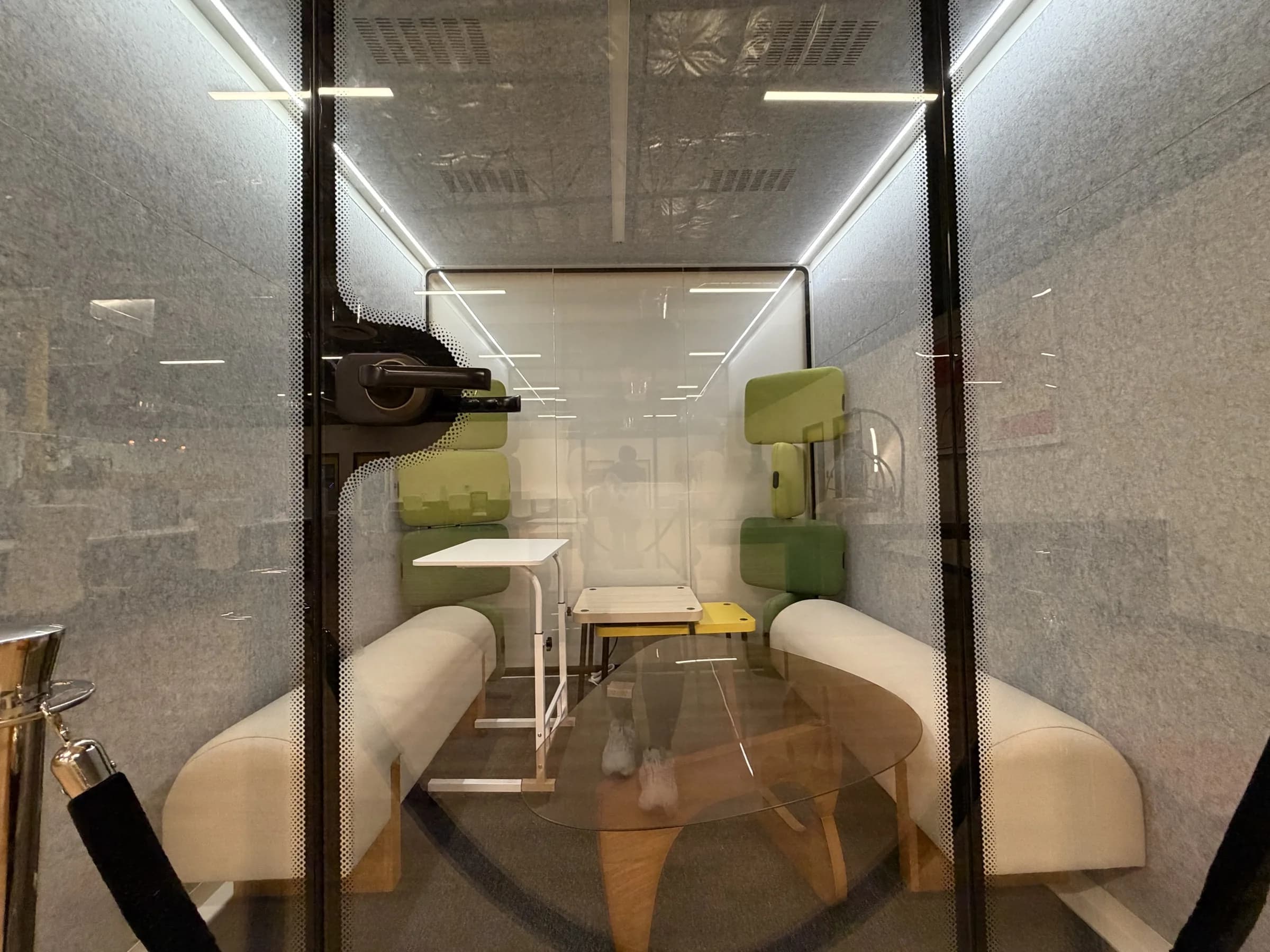 Enclosed phone booth with soft seating and a small table at the Las Vegas workspace