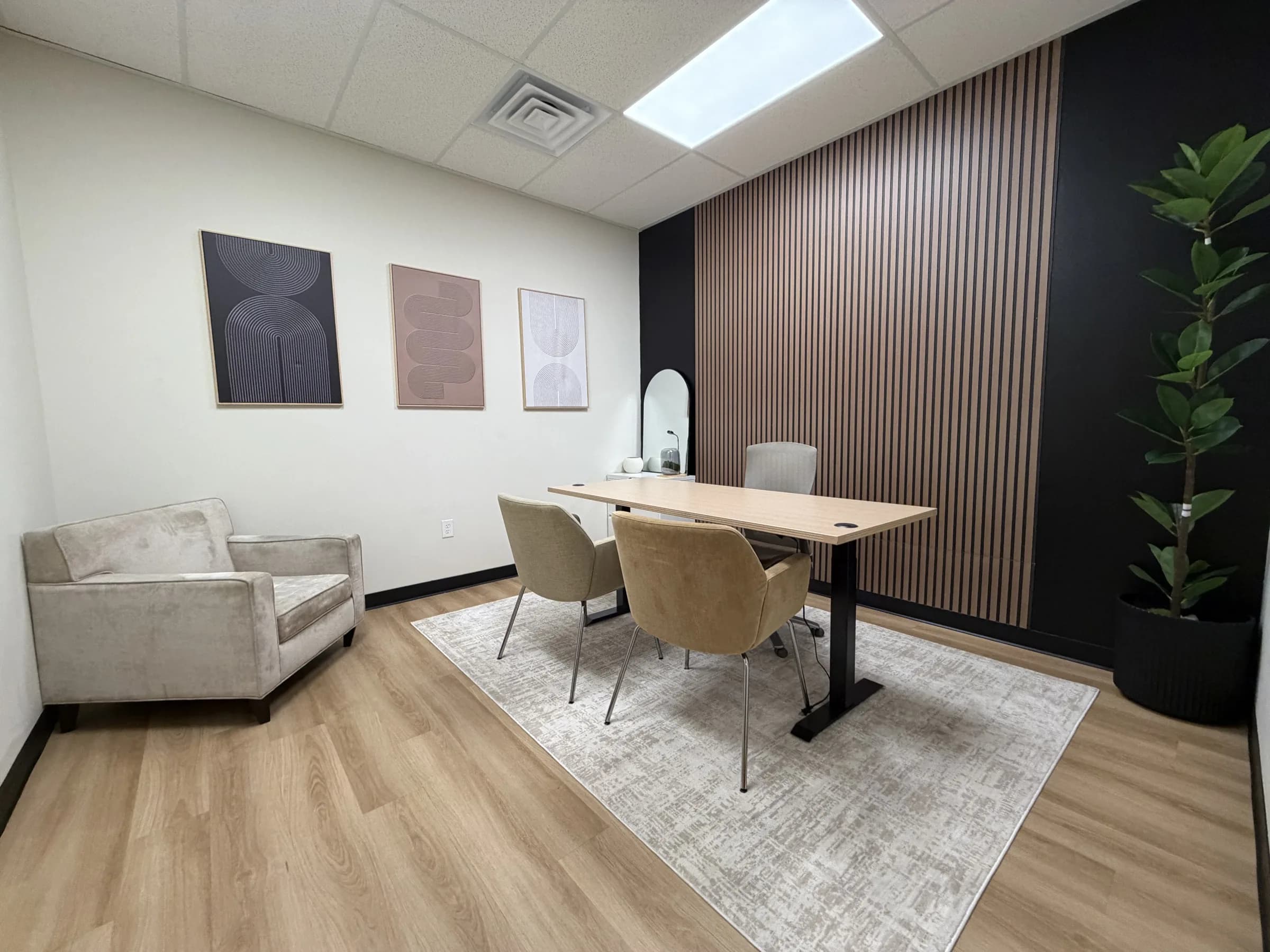 Wide view of a furnished Las Vegas private office with guest seating and a desk