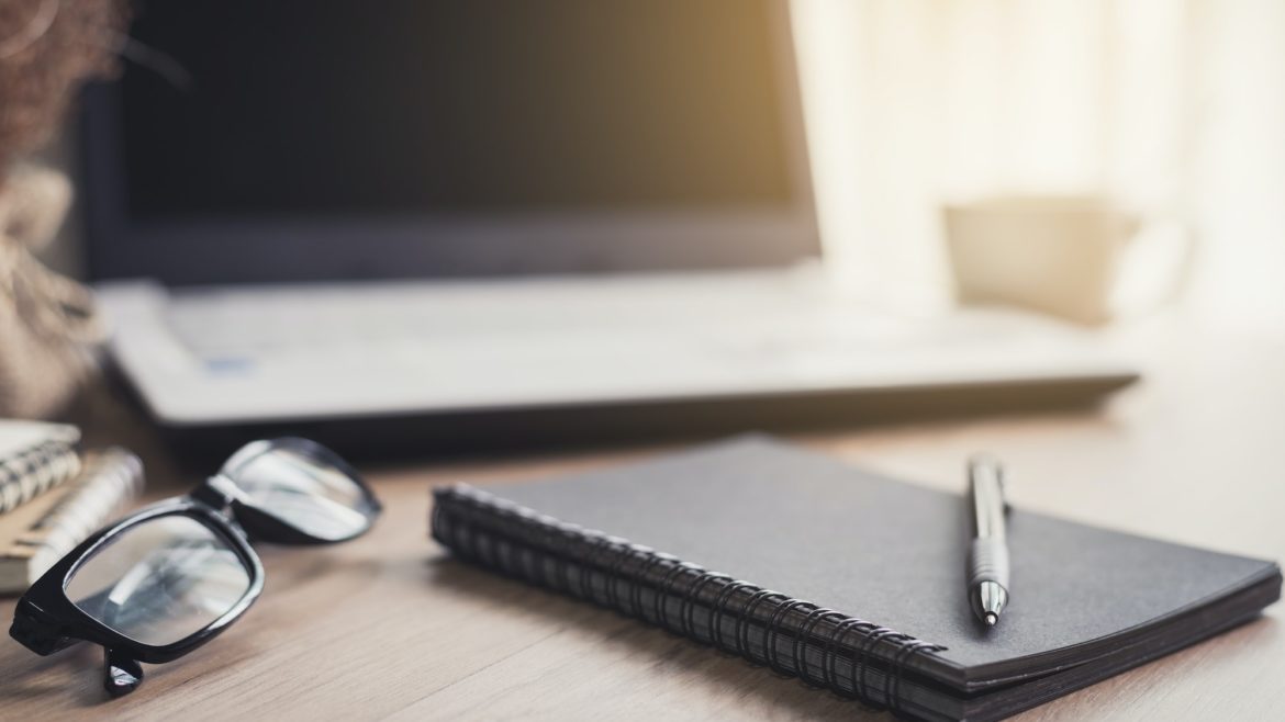 Notebook and laptop in home office with soft light