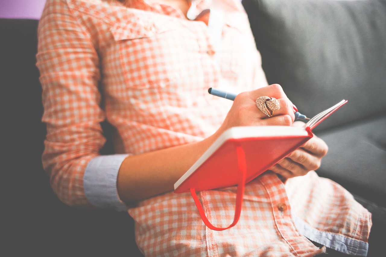 Person writing down the daily tasks.